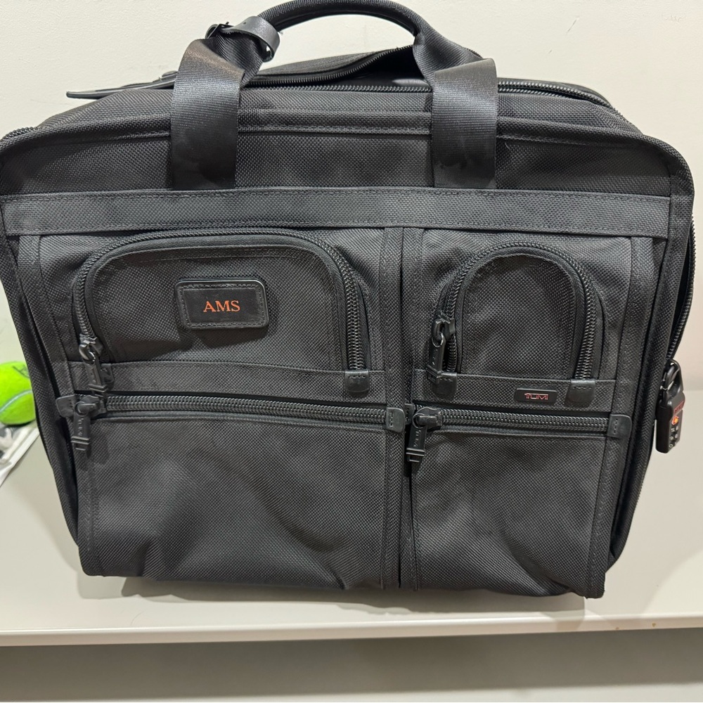 Tumi Alpha Ballistic Nylon rolling briefcase. Tumi store will swap the monogram.